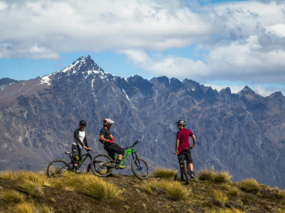 Bikers riding Queenstown mountain bike trail Rude Rock